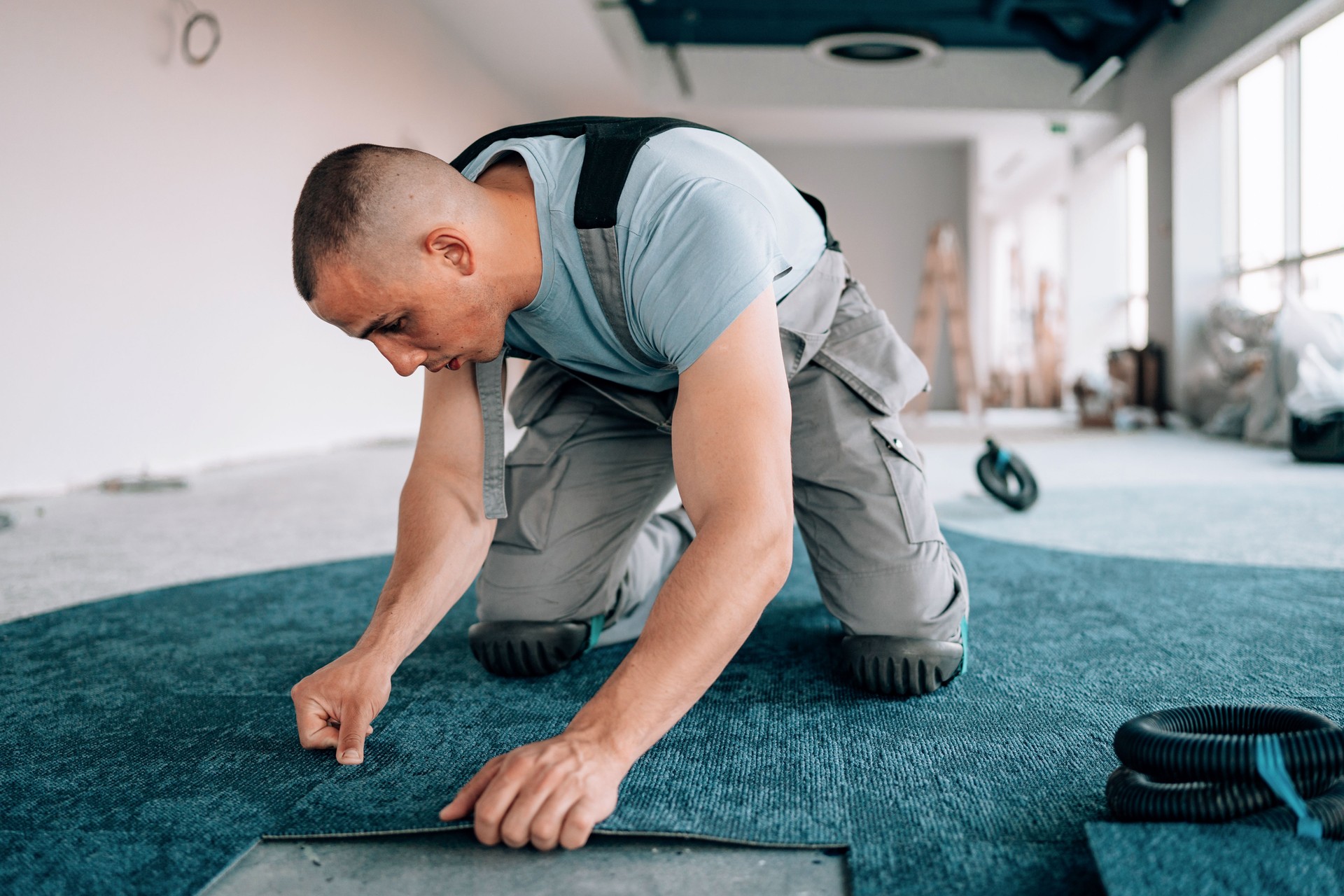 Young man's attention to detail in carpeting business area